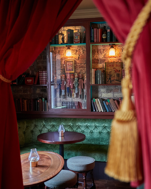 Tables viewed through a partially opened curtain.